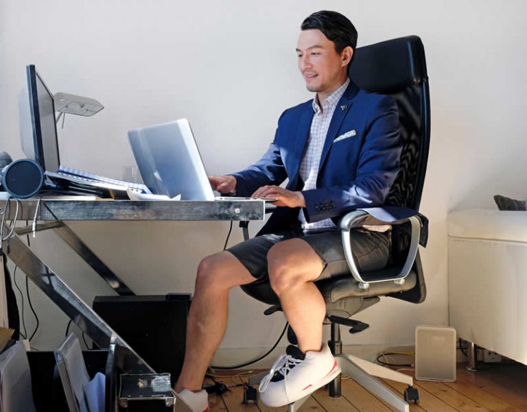 Professional businessman working on laptop in modern office setting for Ontario corporation registration