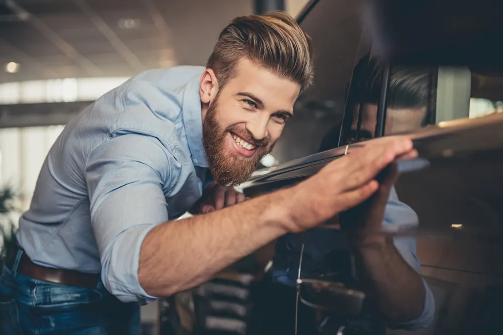 Smiling man starting a car repair business, a potential user case for a Master Business Licence.