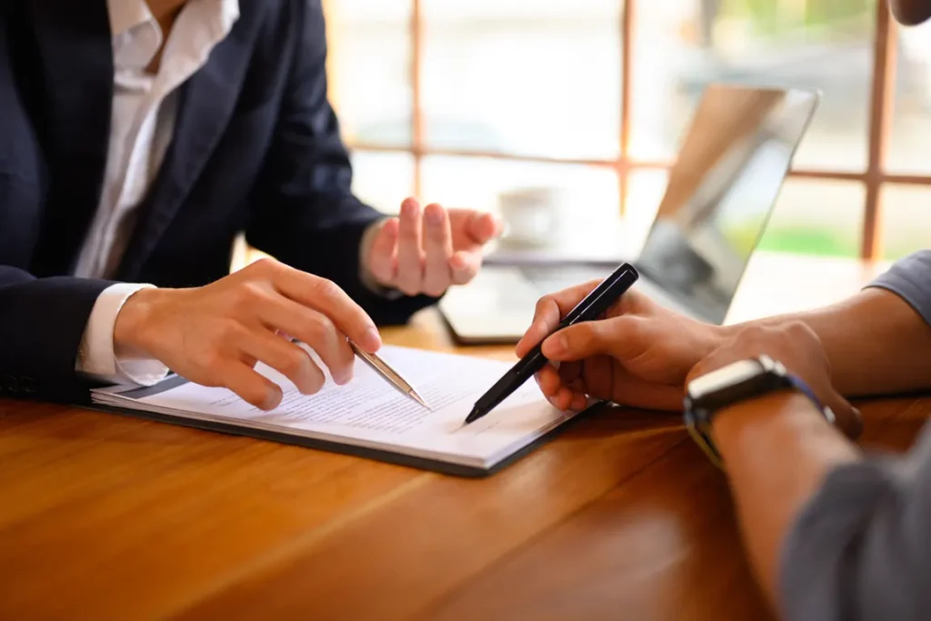 People signing official documents for Articles of Incorporation.