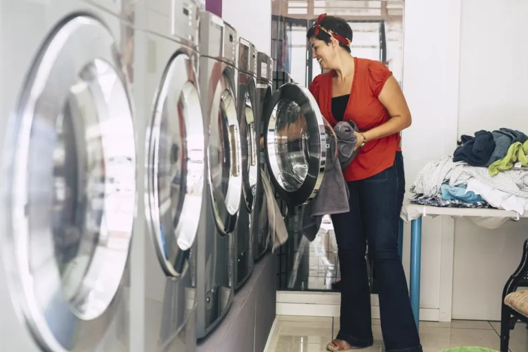 Woman using commercial laundromat - how to start a laundromat business in Canada