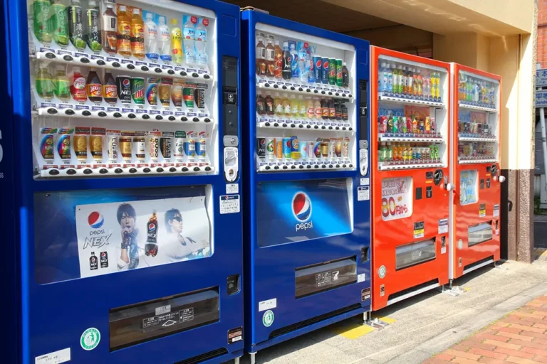 Row of colorful vending machines with beverages and snacks - starting a vending machine business in Ontario guide