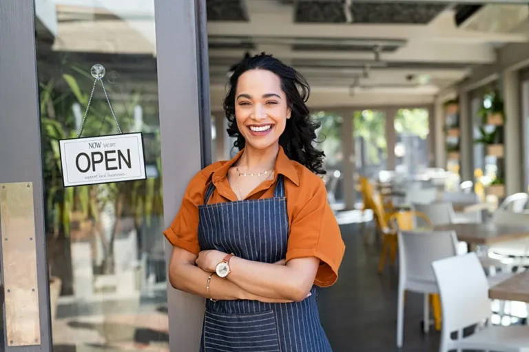 female business owner in front of her shop