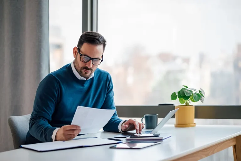Business professional working with corporation profile report paperwork and official business documents at office desk