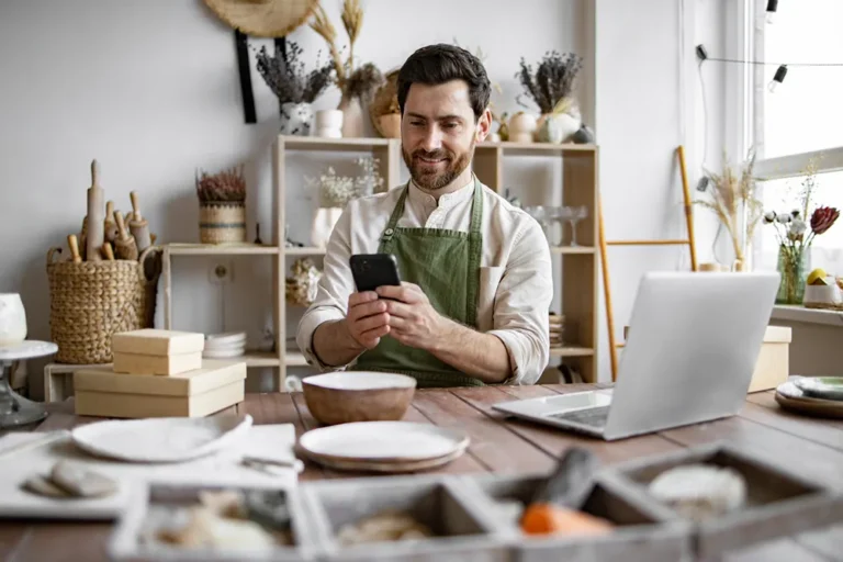 Smiling male small business owner starting his sole proprietorship from his shop.
