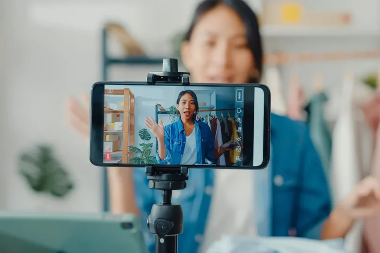 Woman filming social media content on smartphone for influencer business startup in Canada
