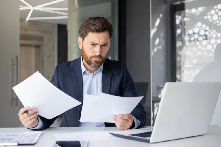 Business owner studying legal documents with concerned expression - Ontario business structure comparison guide