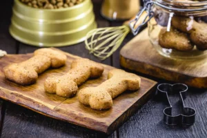 Homemade dog bone-shaped treats on cutting board – perfect for your Ontario dog treat business side hustle.