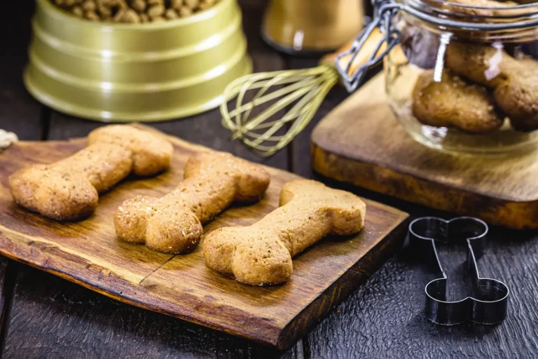 Homemade dog bone-shaped treats on cutting board – perfect for your Ontario dog treat business side hustle.
