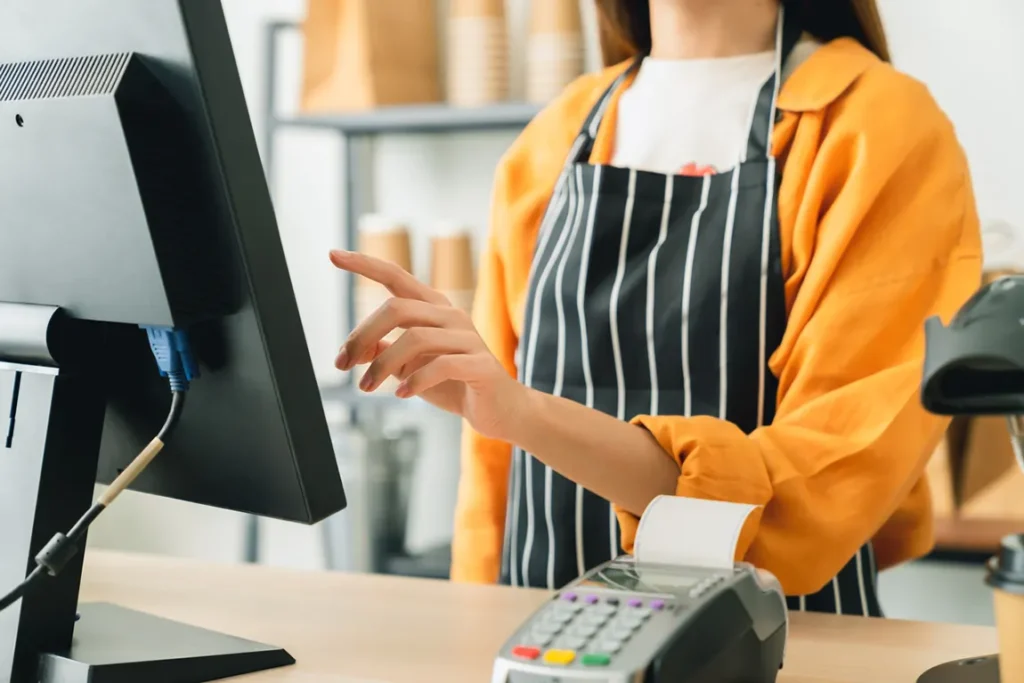 Business owner using POS system to track HST transactions for tax accounting purposes