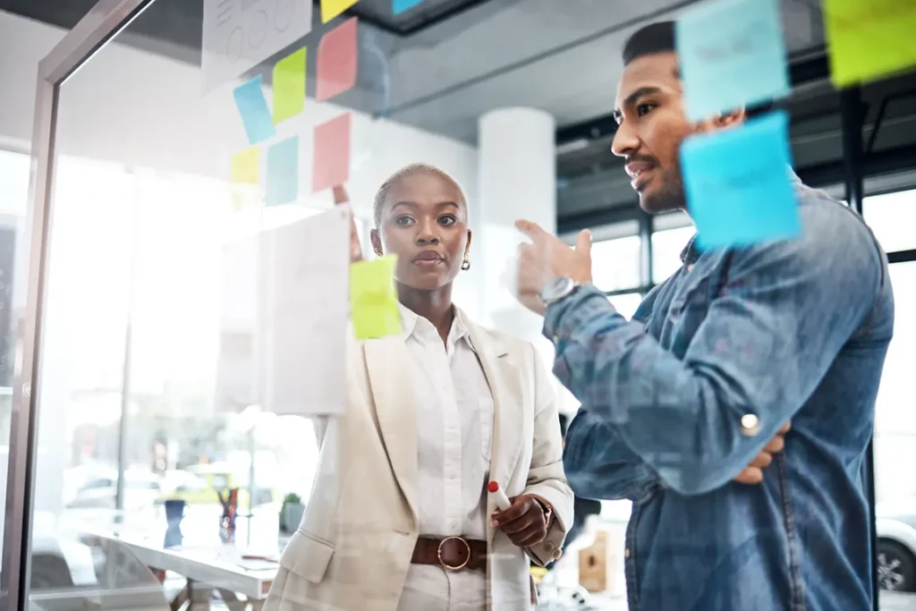 Business professionals planning company restructuring and organizational changes with sticky notes
