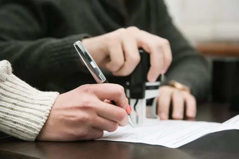 Business owner signing trademark registration documents in Canada for business name protection