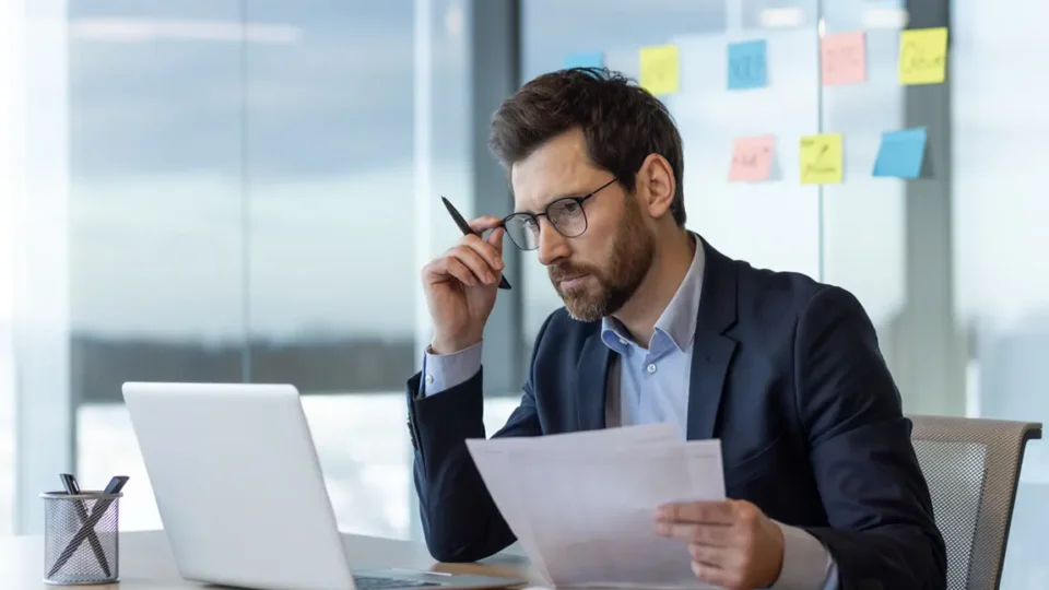 Business owner reviewing Ontario corporation documents while deciding between numbered and named incorporation