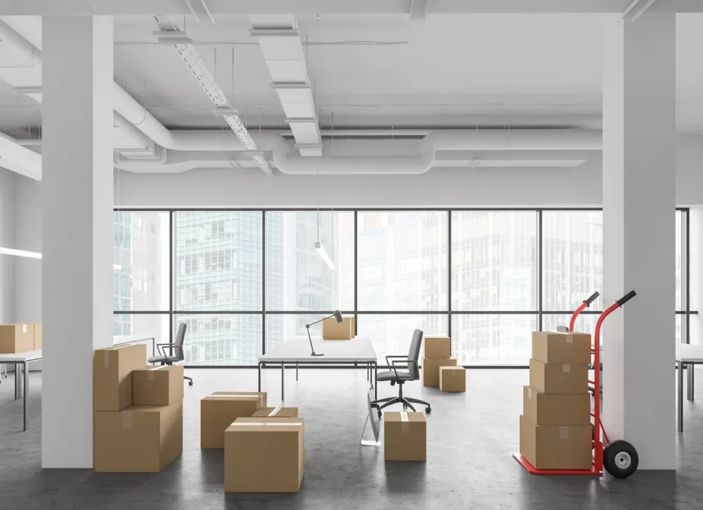 Empty office space with moving boxes representing a business relocation to a new market in Ontario