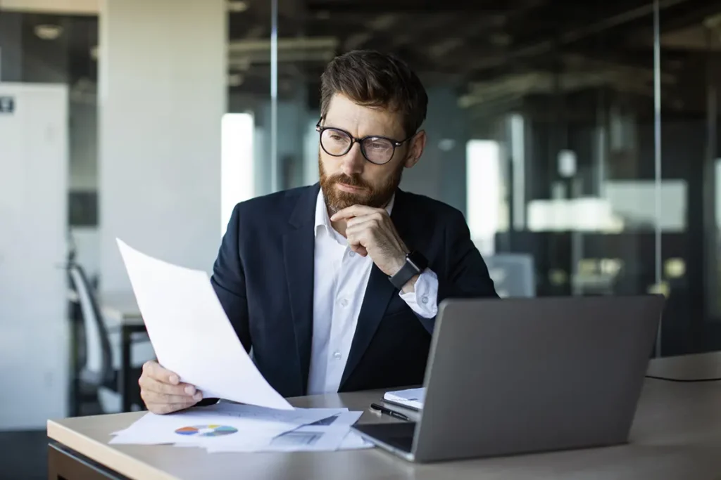 Canadian business owner reviewing corporate structure documents for multiple business ventures