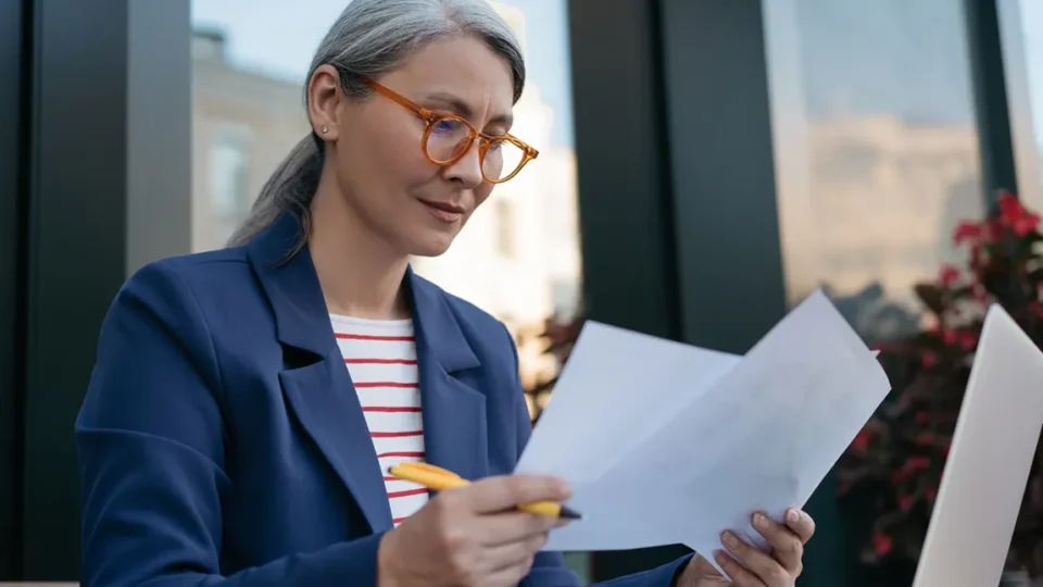 Professional reviewing corporate documents for Ontario corporation reinstatement and compliance