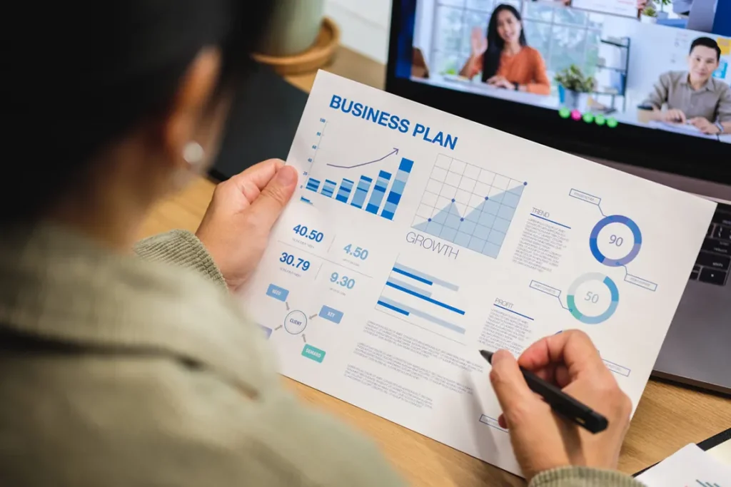Business owner reviewing simple business plan template with financial projections and growth metrics