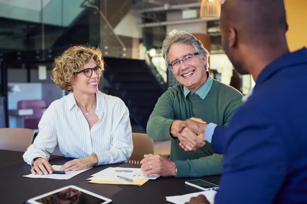 Professional handshake during a business meeting, finalizing an agreement on a loan application.
