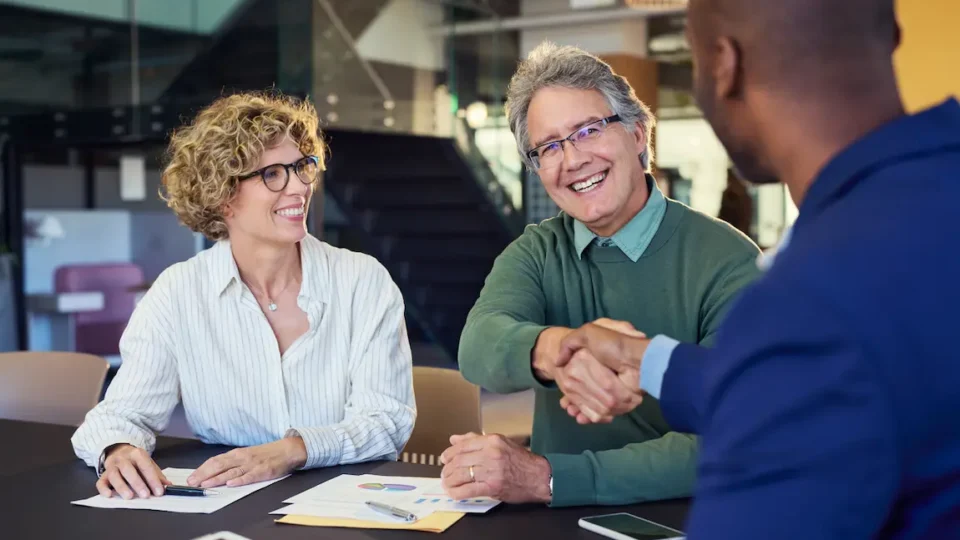 Professional handshake during a business meeting, finalizing an agreement on a loan application.